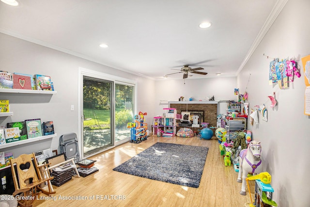 4326 Manitou Dr, Okemos, MI 48864 - game room with a ceiling fan, ornamental molding, recessed lighting, wood finished floors, and a fireplace