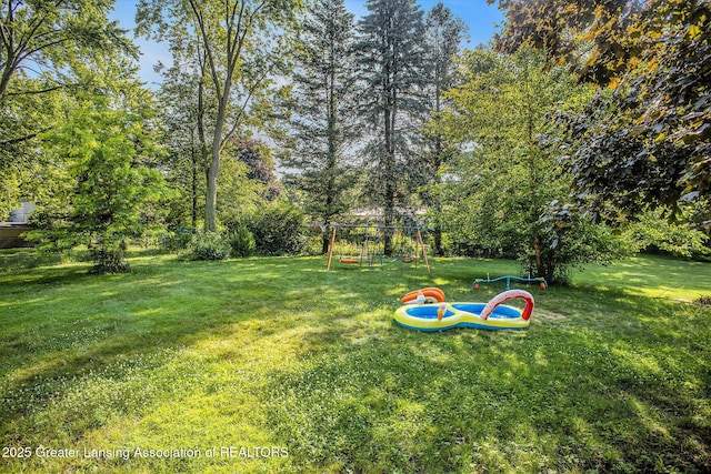 4326 Manitou Dr, Okemos, MI 48864 - view of grassy yard featuring a playground