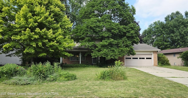 4326 Manitou Dr, Okemos, MI 48864 - view of property hidden behind natural elements featuring a garage, brick siding, driveway, and a front lawn