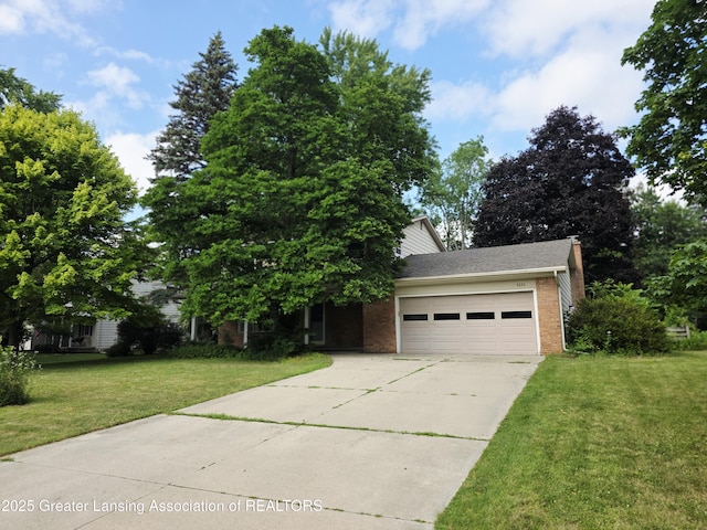 4326 Manitou Dr, Okemos, MI 48864 - obstructed view of property featuring an attached garage, concrete driveway, a front lawn, and brick siding