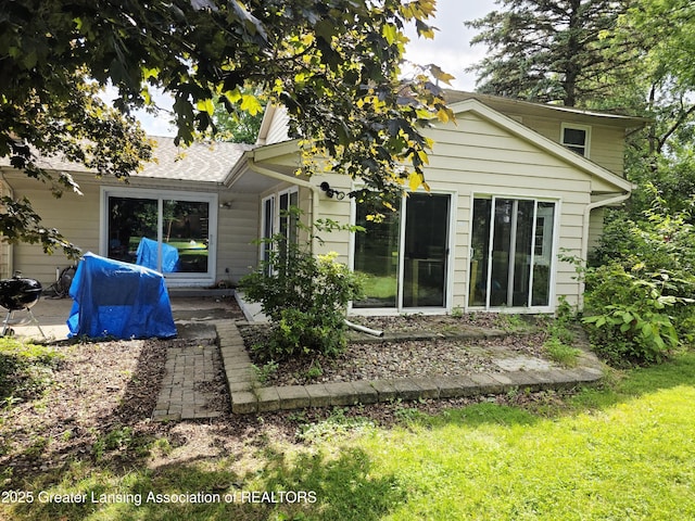4326 Manitou Dr, Okemos, MI 48864 - rear view of property with a patio area and a lawn