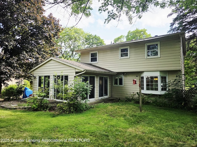 4326 Manitou Dr, Okemos, MI 48864 - back of house with a lawn and a sunroom