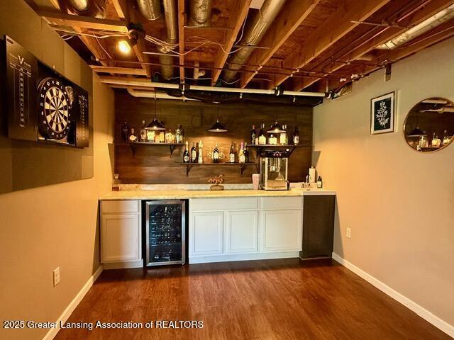 310 Brittany Ln, Mulliken, MI 48861 - indoor wet bar featuring wine cooler, dark wood-style flooring, and decorative light fixtures