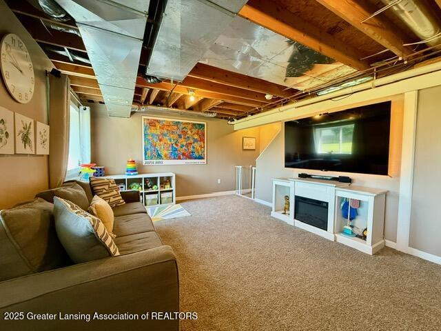 310 Brittany Ln, Mulliken, MI 48861 - living area featuring carpet floors and a glass covered fireplace