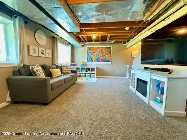 310 Brittany Ln, Mulliken, MI 48861 - carpeted living room featuring a glass covered fireplace and baseboards