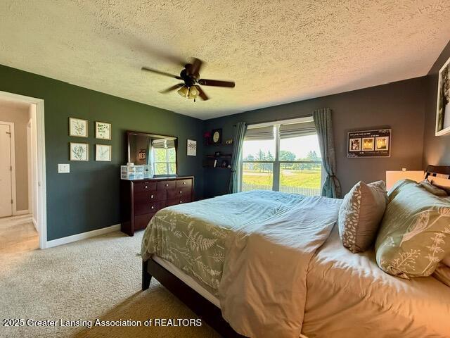 310 Brittany Ln, Mulliken, MI 48861 - bedroom featuring carpet floors, a textured ceiling, and ceiling fan