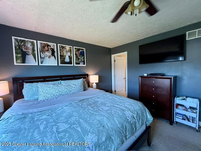 310 Brittany Ln, Mulliken, MI 48861 - carpeted bedroom with a textured ceiling and a ceiling fan