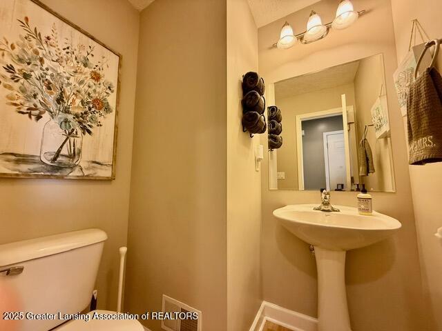 310 Brittany Ln, Mulliken, MI 48861 - half bath featuring toilet and a sink