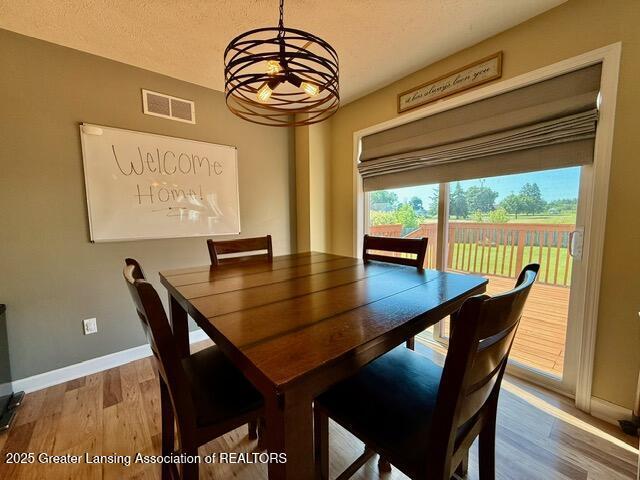 310 Brittany Ln, Mulliken, MI 48861 - dining room with a chandelier and wood finished floors