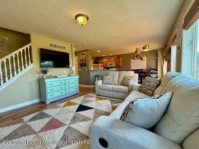 310 Brittany Ln, Mulliken, MI 48861 - living area with stairs and light wood-type flooring
