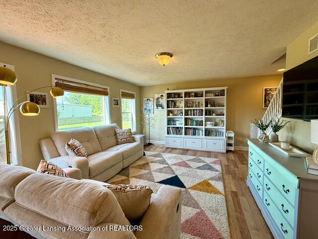 310 Brittany Ln, Mulliken, MI 48861 - living room with a textured ceiling and light wood-type flooring