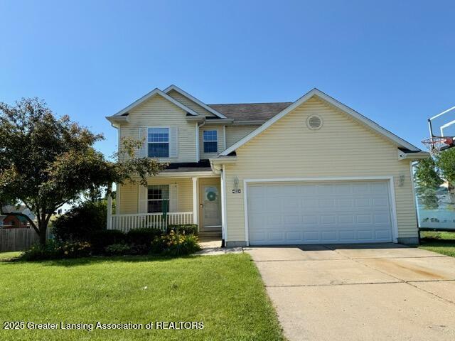 310 Brittany Ln, Mulliken, MI 48861 - view of front of home with covered porch, driveway, a front lawn, and a garage