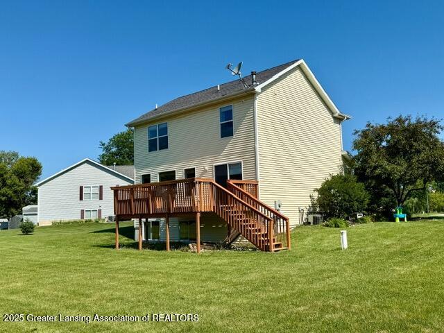 310 Brittany Ln, Mulliken, MI 48861 - back of house featuring a deck, a lawn, and stairway
