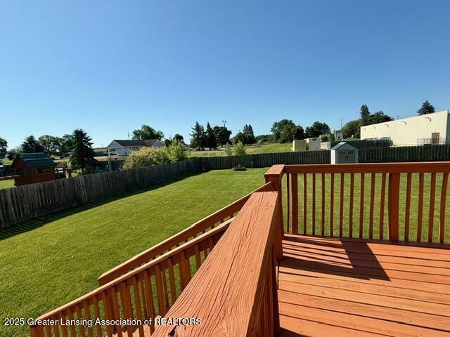 310 Brittany Ln, Mulliken, MI 48861 - deck featuring a fenced backyard and a storage unit