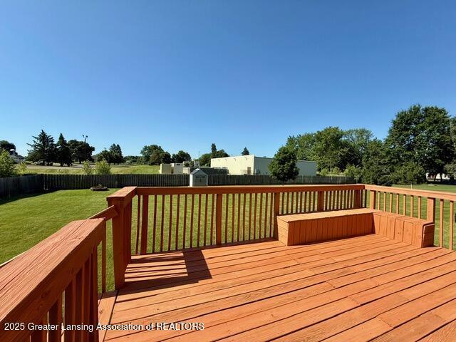 310 Brittany Ln, Mulliken, MI 48861 - deck featuring a fenced backyard and a storage unit