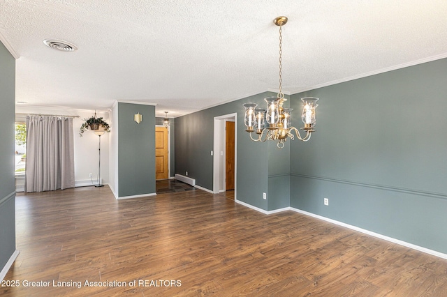 608 Belknap St, Grand Ledge, MI 48837 - unfurnished room featuring a textured ceiling, a chandelier, wood finished floors, and crown molding