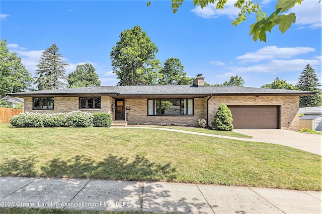 608 Belknap St, Grand Ledge, MI 48837 - view of front of home featuring brick siding, a garage, driveway, and a chimney