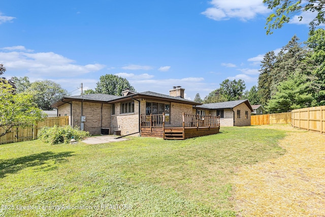 608 Belknap St, Grand Ledge, MI 48837 - rear view of house featuring brick siding, a fenced backyard, a wooden deck, and a chimney