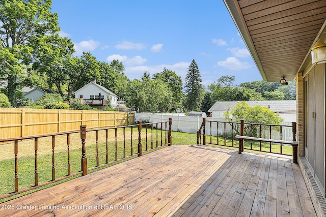 608 Belknap St, Grand Ledge, MI 48837 - deck with a fenced backyard and view of wooded area