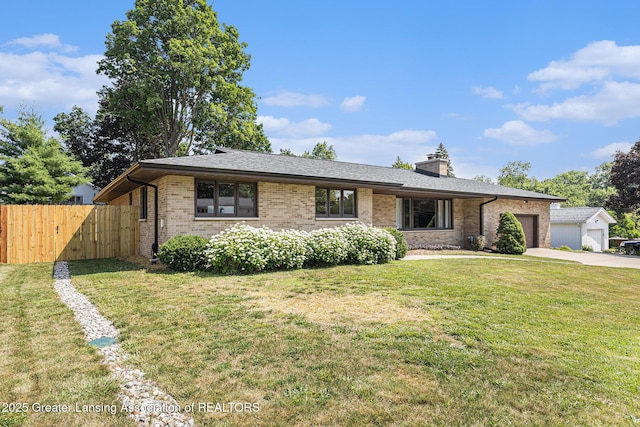 608 Belknap St, Grand Ledge, MI 48837 - view of front of house featuring a garage, brick siding, concrete driveway, a chimney, and roof with shingles