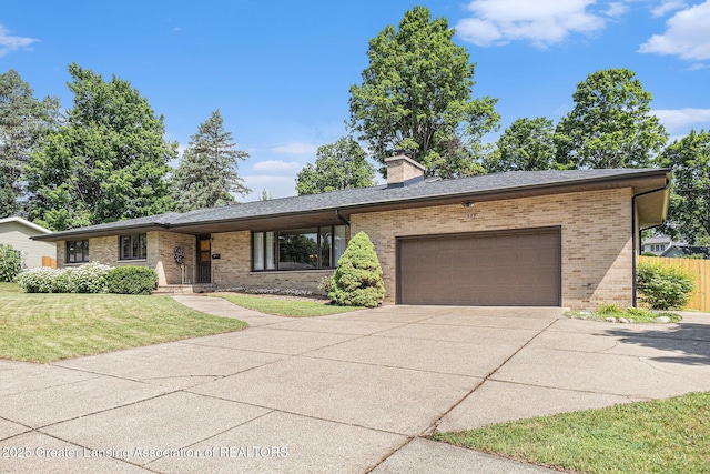608 Belknap St, Grand Ledge, MI 48837 - view of front facade featuring brick siding, an attached garage, concrete driveway, and a chimney