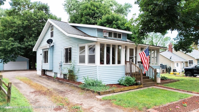 4461 Holt Rd, Holt, MI 48842 - view of front of property with an outbuilding, a garage, and a front yard