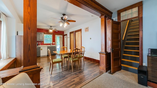 4461 Holt Rd, Holt, MI 48842 - dining space featuring ceiling fan, wood finished floors, stairs, and ornate columns