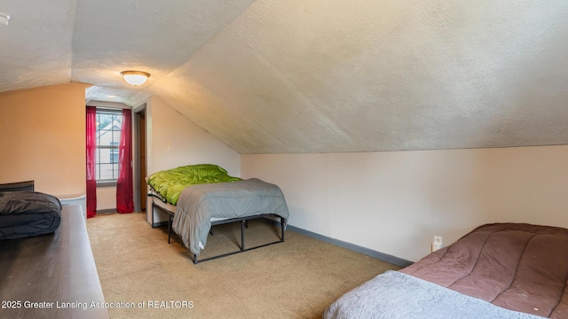 4461 Holt Rd, Holt, MI 48842 - bedroom with carpet, a textured ceiling, and vaulted ceiling