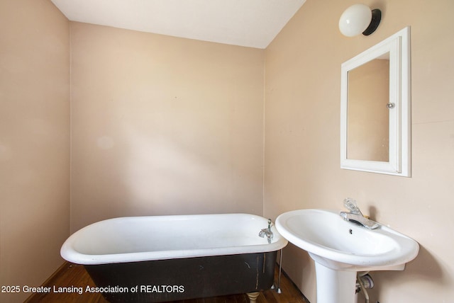 720 Kennedy St, Jackson, MI 49202 - full bath featuring a freestanding bath and wood finished floors