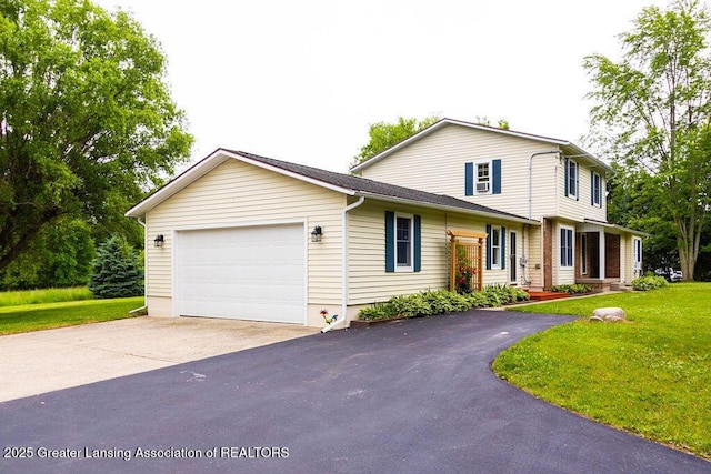 3536 Burkley Rd, Williamston, MI 48895 - traditional-style house featuring driveway, an attached garage, and a front lawn