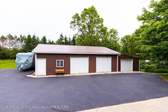 3536 Burkley Rd, Williamston, MI 48895 - detached garage featuring view of scattered trees