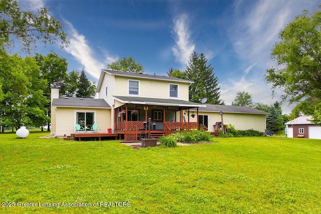 3536 Burkley Rd, Williamston, MI 48895 - view of front of home featuring a front lawn, a chimney, and a deck