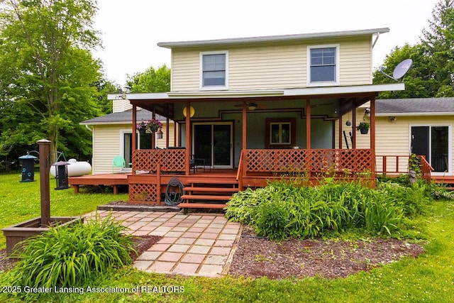 3536 Burkley Rd, Williamston, MI 48895 - rear view of house with a wooden deck, ceiling fan, and a yard