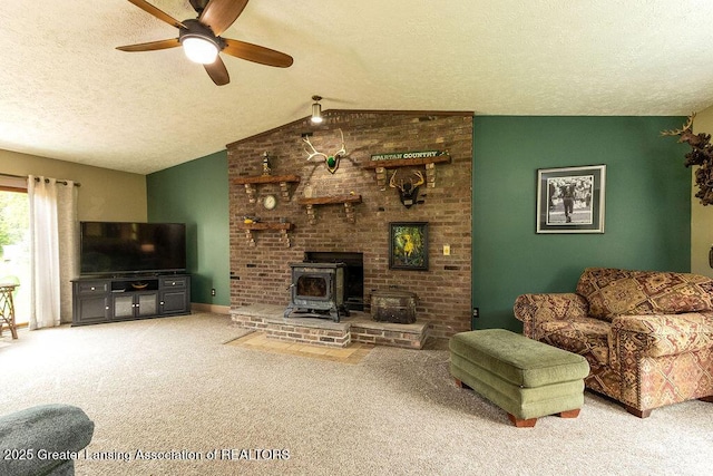 3536 Burkley Rd, Williamston, MI 48895 - living area featuring carpet flooring, ceiling fan, lofted ceiling, a textured ceiling, and a wood stove