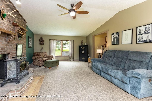 3536 Burkley Rd, Williamston, MI 48895 - living area featuring vaulted ceiling, carpet, a ceiling fan, a wood stove, and cooling unit