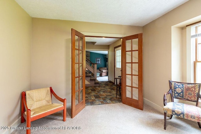 3536 Burkley Rd, Williamston, MI 48895 - sitting room featuring french doors, carpet floors, stairs, and a textured ceiling