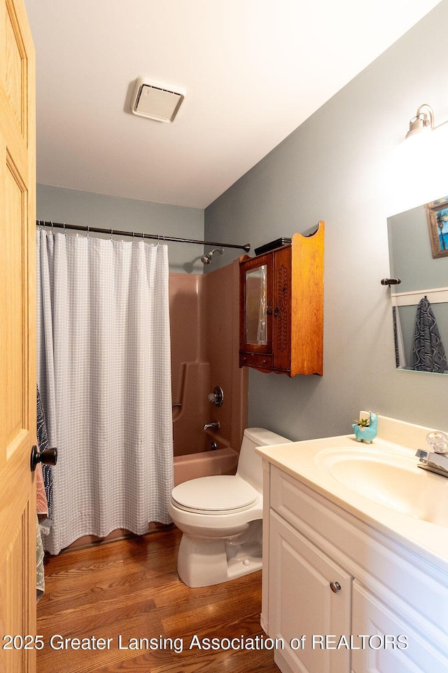 3536 Burkley Rd, Williamston, MI 48895 - full bath featuring vanity, shower / bathtub combination with curtain, and wood finished floors