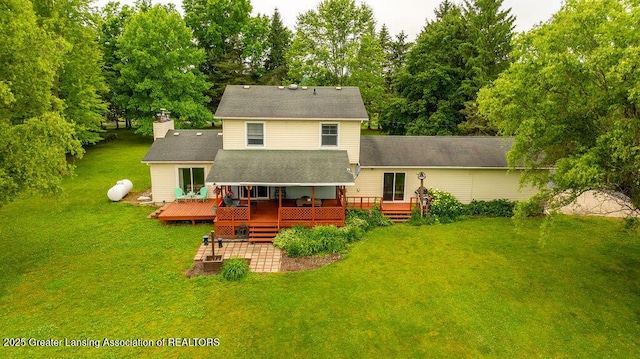 3536 Burkley Rd, Williamston, MI 48895 - back of property with a yard, a chimney, a wooden deck, and view of scattered trees