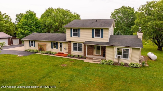 3536 Burkley Rd, Williamston, MI 48895 - view of front of property featuring a chimney, cooling unit, a front yard, and a detached garage