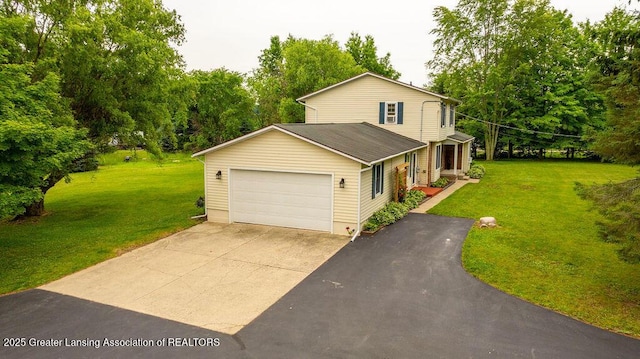 3536 Burkley Rd, Williamston, MI 48895 - traditional home with driveway, an attached garage, a front yard, and view of scattered trees