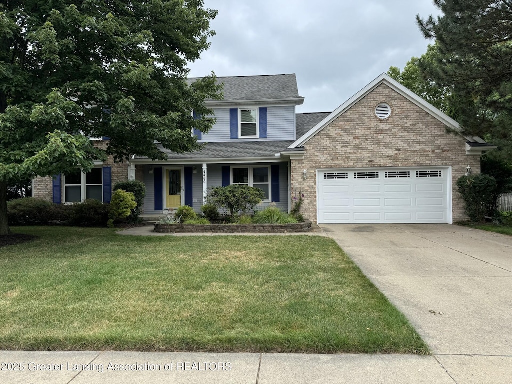 4460 Satinwood Dr, Okemos, MI 48864 - traditional home featuring an attached garage, brick siding, concrete driveway, a front lawn, and roof with shingles