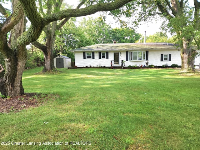 3612 Dell Rd, Holt, MI 48842 - ranch-style house featuring a storage shed and a front yard