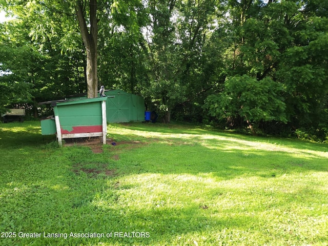 3612 Dell Rd, Holt, MI 48842 - view of green lawn with a shed