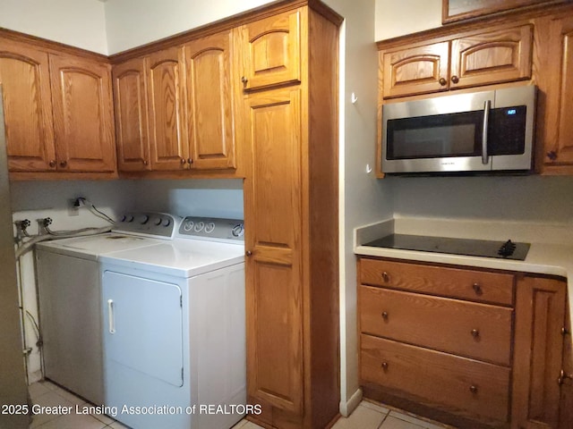 3612 Dell Rd, Holt, MI 48842 - washroom with separate washer and dryer, cabinet space, and light tile patterned flooring