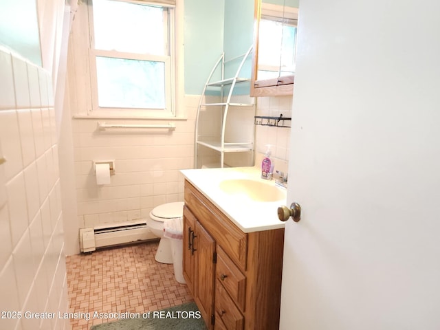 3612 Dell Rd, Holt, MI 48842 - bathroom featuring a baseboard heating unit, vanity, and tile walls