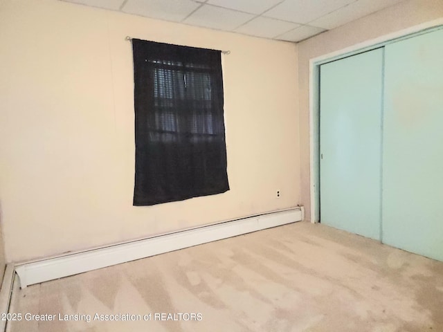 3612 Dell Rd, Holt, MI 48842 - spare room featuring baseboard heating, carpet flooring, and a paneled ceiling