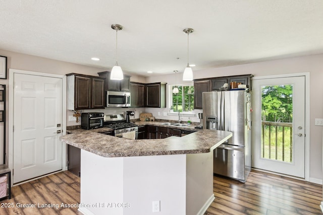 4930 N Campers Trl, Perrinton, MI 48871 - kitchen featuring appliances with stainless steel finishes, dark wood-style floors, dark brown cabinets, pendant lighting, and recessed lighting