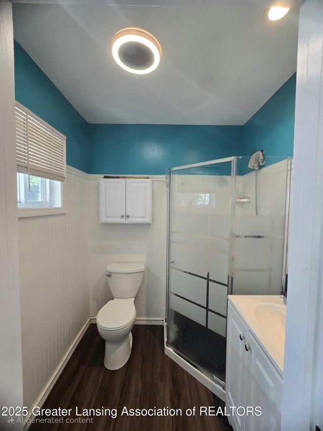 412 N Hickory St, Owosso, MI 48867 - bathroom featuring wood finished floors, a stall shower, and vanity
