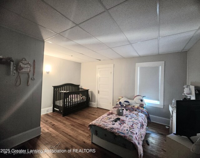 412 N Hickory St, Owosso, MI 48867 - bedroom featuring a drop ceiling and wood finished floors