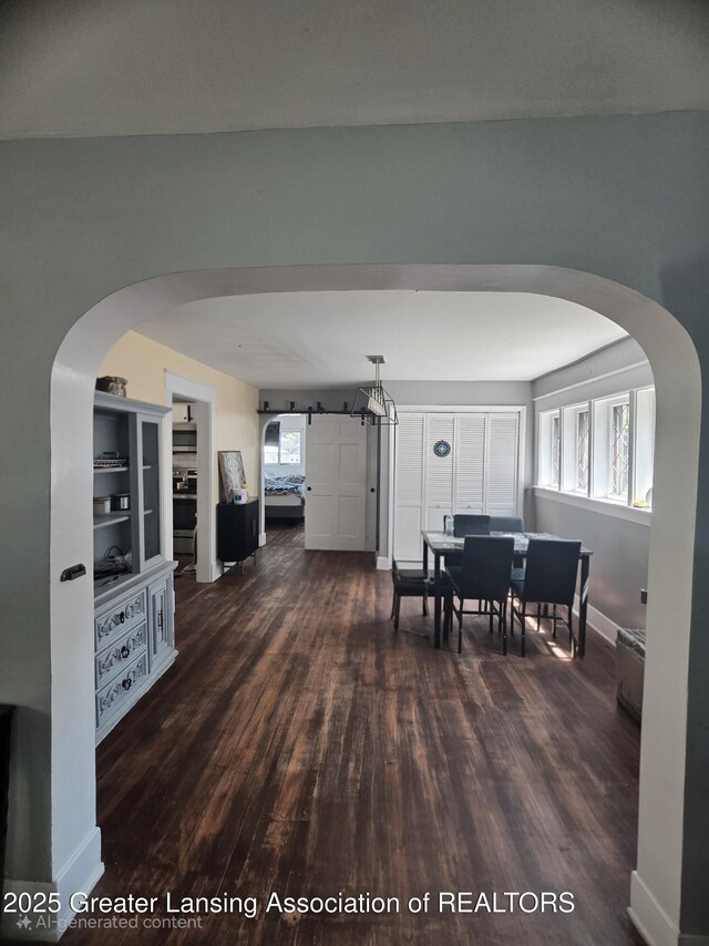 412 N Hickory St, Owosso, MI 48867 - dining room with dark wood-style floors and arched walkways
